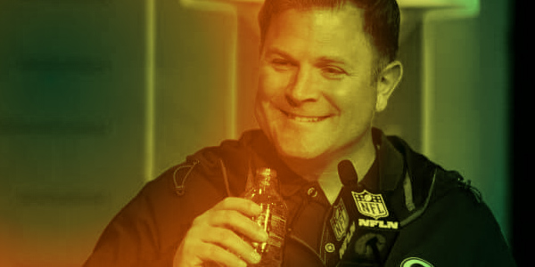Featured image for blog post on Brian Gutekunst trolling Aaron Rodgers. It shows Gutekunst smiling while drinking a water.